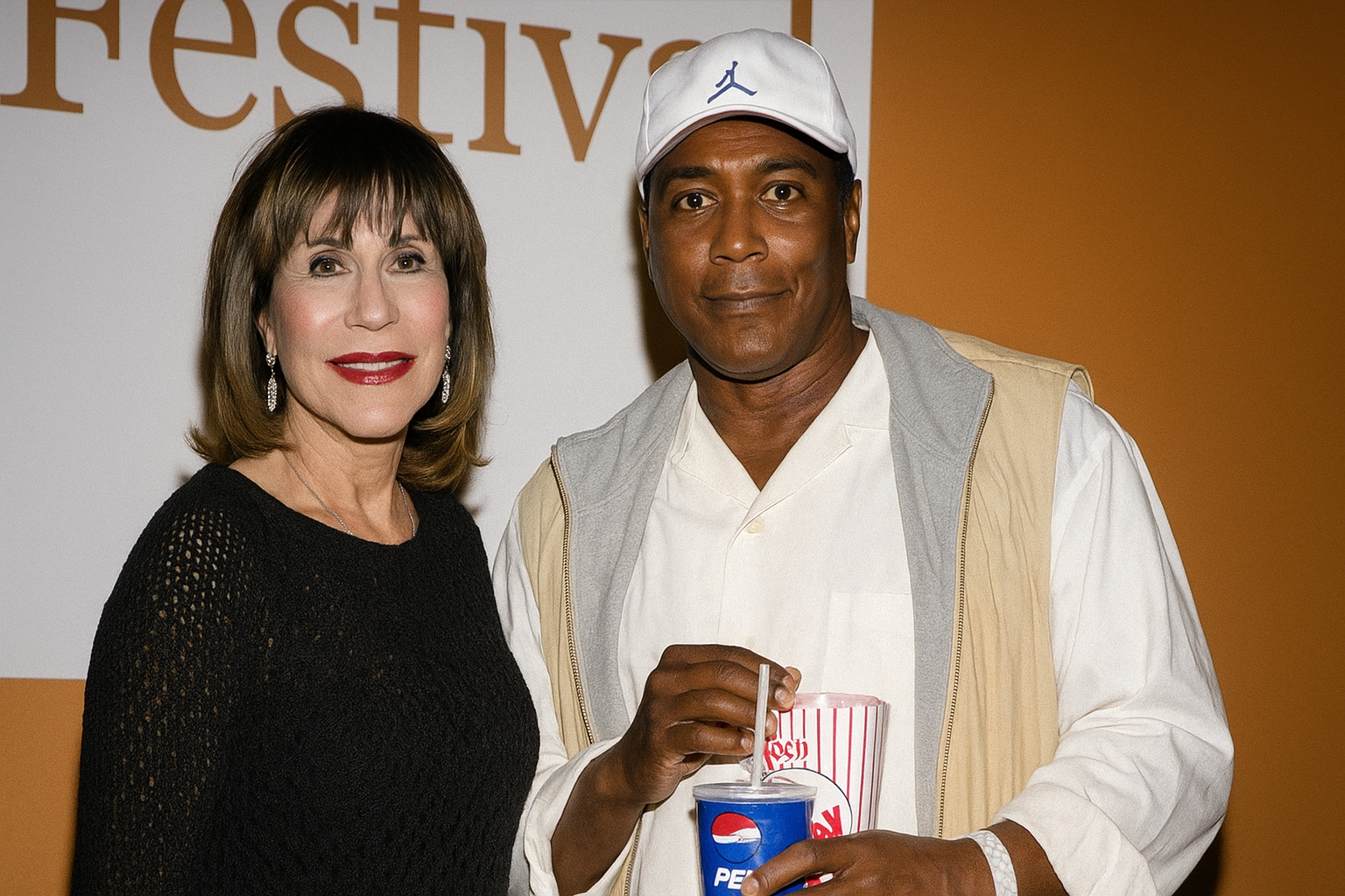 Sale Johnson with Ahmad Rashad at a festival, smiling together — featured banner image for biography of Woody Johnson’s ex-wife.